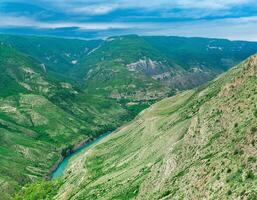 Mountain landscape in the Caucasus in Dagestan, view of the canyon of the Sulak River with the village of Old Zubutli in the distance on the slope photo
