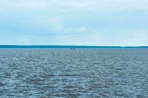 waterscape of Lake Onega, the silhouette of drakkar is visible in the distance photo
