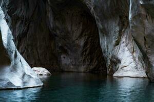 narrow rocky canyon of a mountain river with calm blue water in Goynuk, Turkey photo