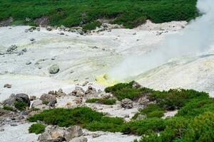 crystallized sulfur around a solfatara in the fumarole field on the slope of a volcano photo