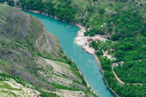 top view of the mountain river Sulak in Dagestan with a tourist boat base photo