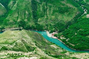 top view of the mountain river Sulak in Dagestan with a tourist boat base photo