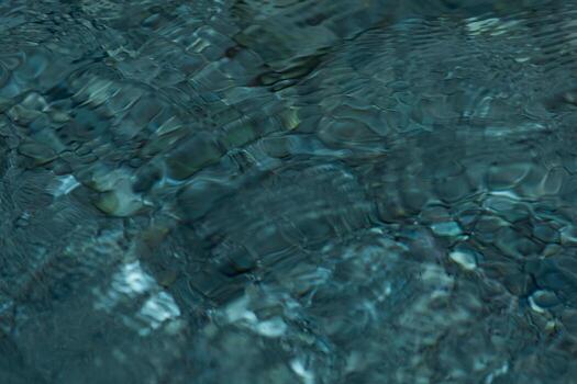 abstract blurred background - the surface of a transparent clean reservoir with circles from drops photo