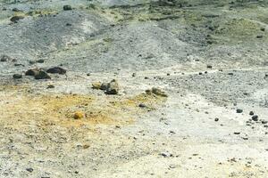 desert soil with multi-colored deposits of minerals in the area of volcanic gases in the solfataric field photo