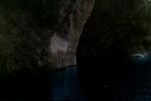 clean underground cave river in steep stone banks in the dark photo