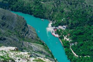 top view of the mountain river Sulak in Dagestan with boat jetty photo