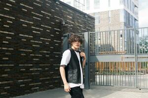 young man on the street against the urban landscape photo