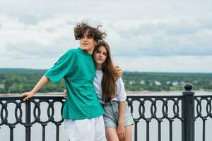 couple of young people hugging against a blurred river landscape photo