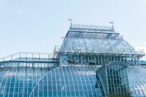 section of a glass dome of vintage tropical flower greenhouse photo