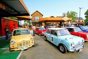 Ayutthaya, Thailand - December 6, 2023 Many colorful Old classic Mini cooper car parked at meeting point. Transportation, Colorful vehicle and Small car concept photo