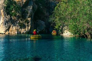 people on an inflatable boats rafting down the blue water canyon in Goynuk, Turkey photo