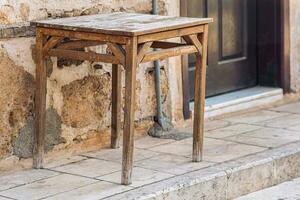 old table on the street next to the vintage building photo