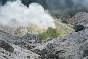 tower of crystallized sulfur around a solfatara in the fumarole field on the slope of a volcano photo