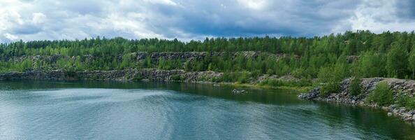 panorama with a clear lake on the site of an old stone quarry photo