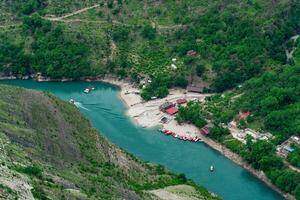 top view of the mountain river Sulak in Dagestan with a tourist boat base photo