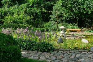 stone lantern on a small island in the middle of a pond in a Japanese garden photo