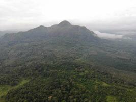 a view of the mountains from a hillside. Serelo Hill is located in Perangai Village, Lahat regency, and it becomes one of popular landmark in Lahat regency. photo