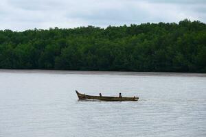 The Biodiversity of bangka Belitung Island, two people in a small boat on the water photo