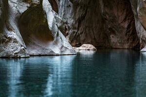 narrow rocky canyon of a mountain river with calm blue water in Goynuk, Turkey photo