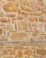 background, texture - rough masonry from wild stone and cement on a wooden frame photo