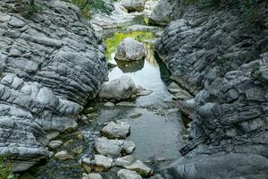 mountain landscape with a river in a rocky bed photo