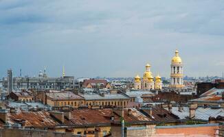 view of the rooftops in the historical center of St. Petersburg during the rain photo