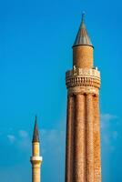 ancient minarets with loudspeakers against the sky photo