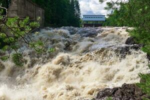 waterfall during opened locks for idle discharge of water at a small hydroelectric power station photo