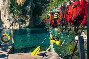 Pier for rafting with folded equipment - life jackets, helmets, oars. Goynuk canyon, Antalya photo