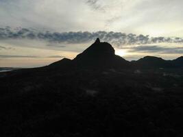 a view of the mountains from a hillside. Serelo Hill is located in Perangai Village, Lahat regency, and it becomes one of popular landmark in Lahat regency. photo