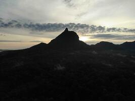 a view of the mountains from a hillside. Serelo Hill is located in Perangai Village, Lahat regency, and it becomes one of popular landmark in Lahat regency. photo