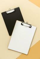 AI generated view of black and white clipboards on a soft beige background photo