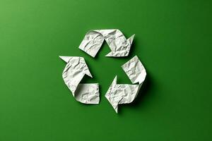 AI generated Recycle symbol made of white paper on green background photo