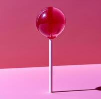 AI generated a lollipop on a pink background photo