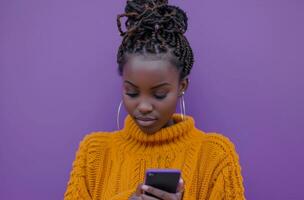 AI generated young african woman holding a smartphone against purple background photo