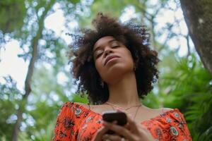 AI generated young afro american woman holding a phone outdoors photo