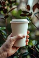 AI generated person hand holding cup of coffeewhite disposable paper cup photo