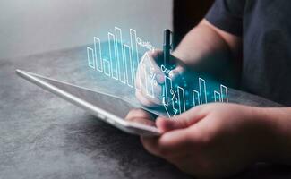 Woman use digital tablet for business cost and quality control. Strategy and project management concept. Business woman working with holographic graph of quality control growth and cost reduction. photo