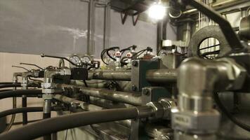 Pressure gauge ant other equipment inside an industrial room at the factory. Stock footage. Heating system of the plant, efficient water treatment concept. photo