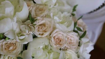 Wedding bouquet of roses. Bride's bouquet on wedding day. Bouquet of different flowers. Bouquet of beautiful pink and white or red roses on the dressing stool. Roses photo