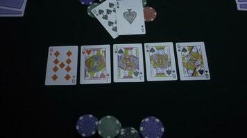 Detail of a royal flush on black background. Royal Flush of spade in poker game on a black background. Player collected The Royal Flush on a green poker table against black. photo