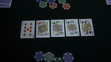 Detail of a royal flush on black background. Royal Flush of spade in poker game on a black background. Player collected The Royal Flush on a green poker table against black. photo