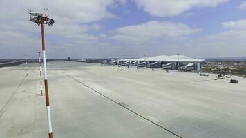 Aerial view of the modern international airport terminal. Traveling around the world. Empty airport aerial. View of runway at the airport. Airfield marking on taxiway is heading to runway photo