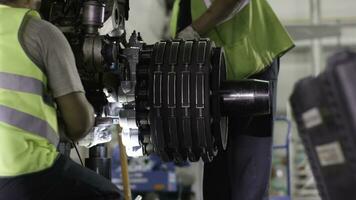 Calm workers controlling aircraft machine and chassis. Aircraft maintenance mechanic inspects plane chassis. Installing new chassis on a plane. Engineer checks chassis. Airport worker mechanic photo