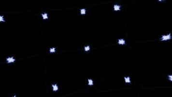 Black background with illuminated lights. Motion. Small burning stars in animation that slowly rotate. photo