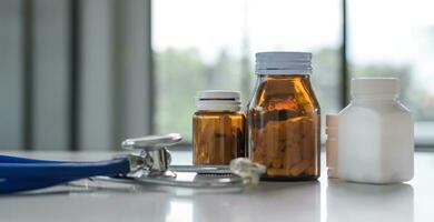 Medicine and stethoscope placed on the doctor's desk health care medicine. photo