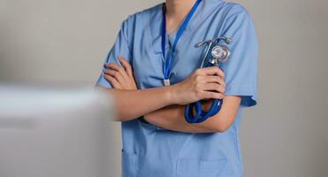 Close up a doctor standing with his arms crossed holding a stethoscope, a doctor from the hospital. Medical staff people. Team of doctor and nurse in hospital. Concept Of Medical photo