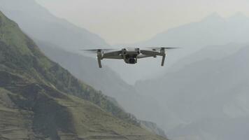 Flying drone in air. Action. Drone flies over beautiful mountain landscape on sunny day. Drone in air shoots mountain landscape photo