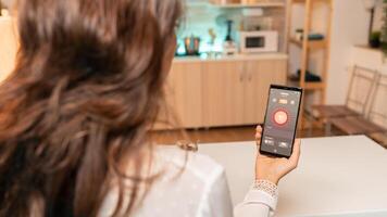 Woman hands holding phone with smart app for home lighting. Person in apartment holding telephone with touchscreen and app for lights. photo