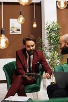 Diverse individuals dressed with suits engage in business related activities, highlighting collaboration and teamwork. Partners discussing freely, exchanging new professional ideas. photo